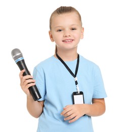 Photo of Little girl with microphone pretending to be journalist on white background. Dreaming of future profession