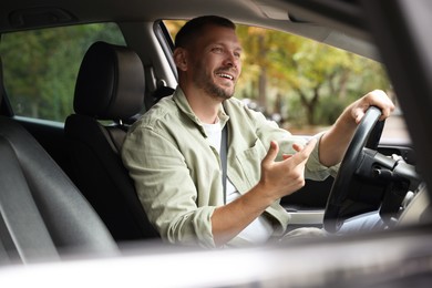 Photo of Man driving modern car, view through window