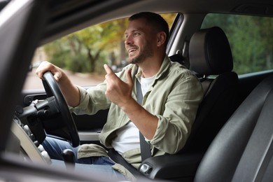 Photo of Man driving modern car, view through window