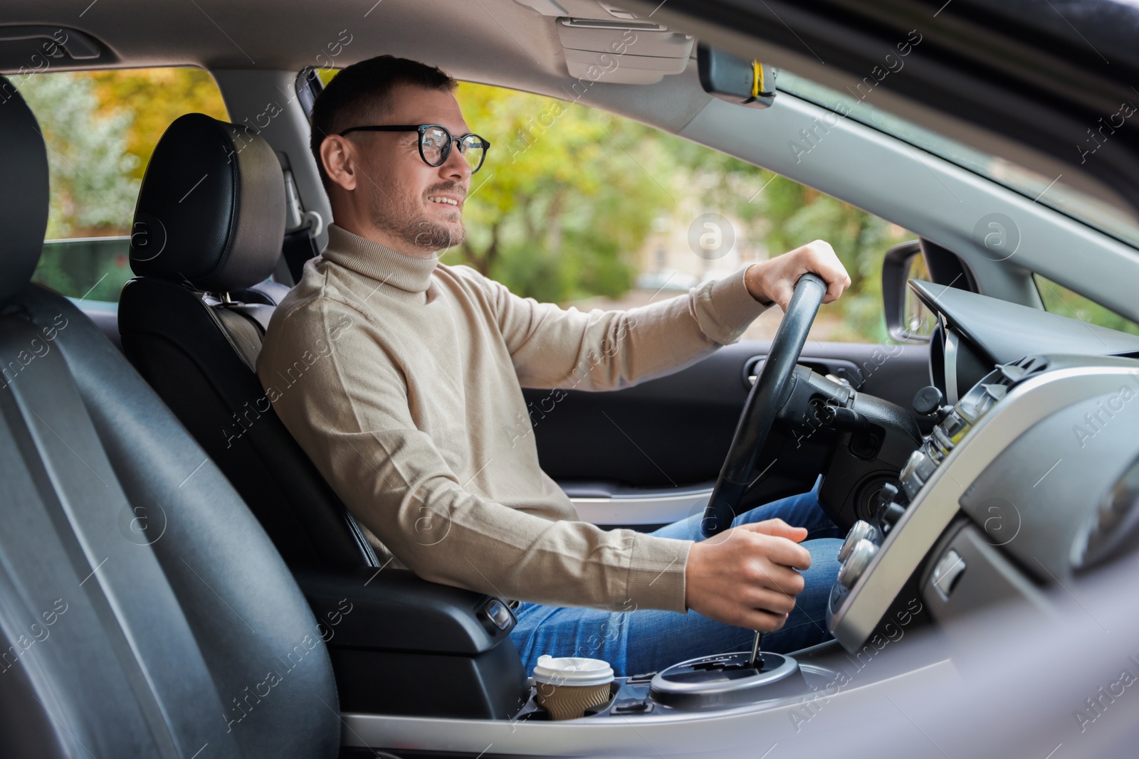 Photo of Man driving modern car, view through window