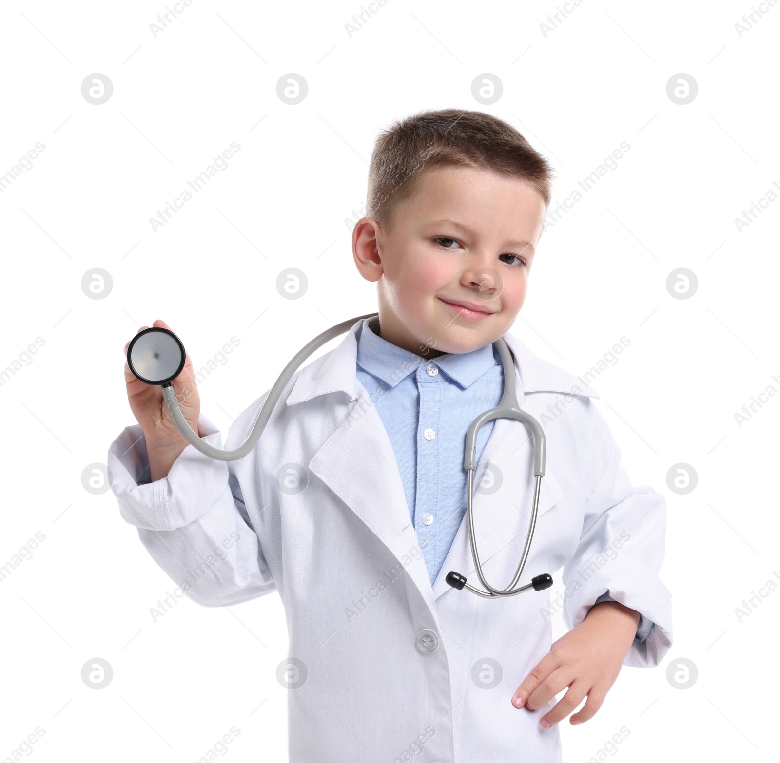 Photo of Little boy with stethoscope pretending to be doctor on white background. Dreaming of future profession