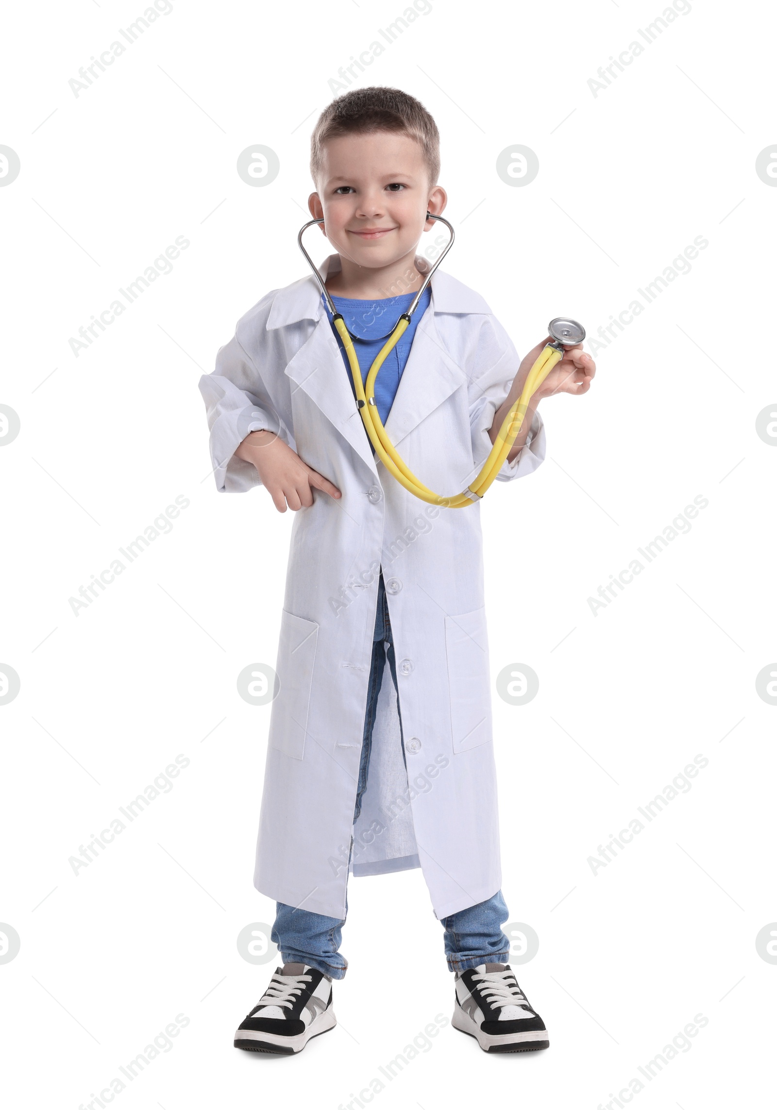 Photo of Little boy with stethoscope pretending to be doctor on white background. Dreaming of future profession