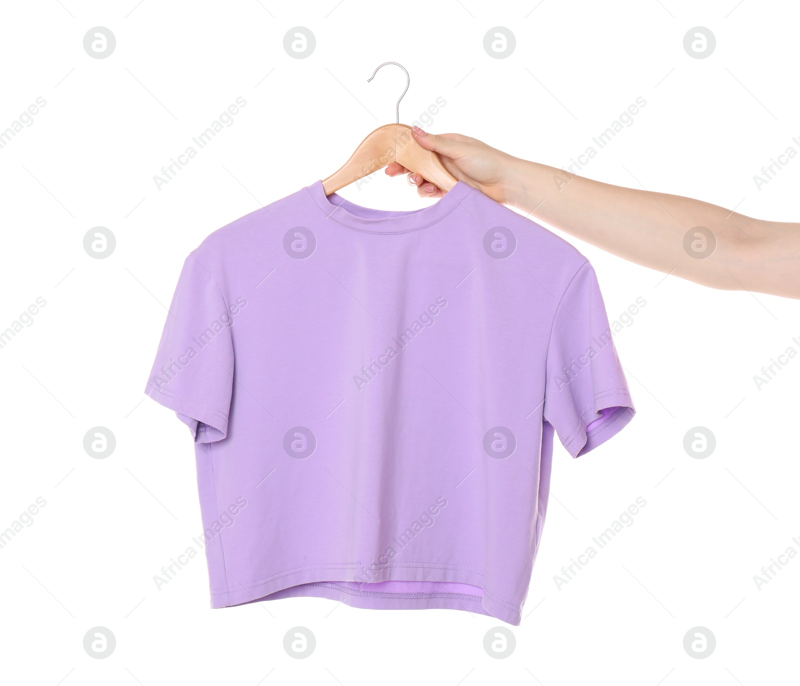 Photo of Woman holding hanger with violet t-shirt on white background, closeup