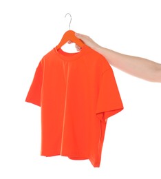 Photo of Woman holding hanger with red t-shirt on white background, closeup