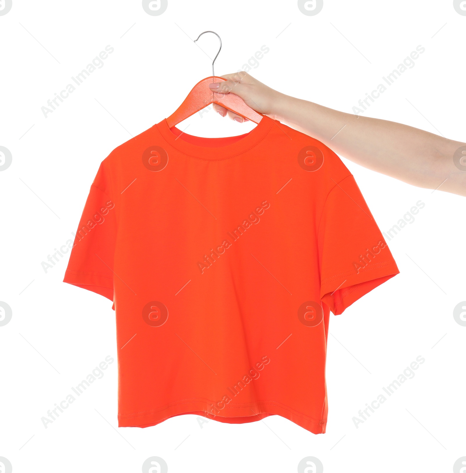 Photo of Woman holding hanger with red t-shirt on white background, closeup