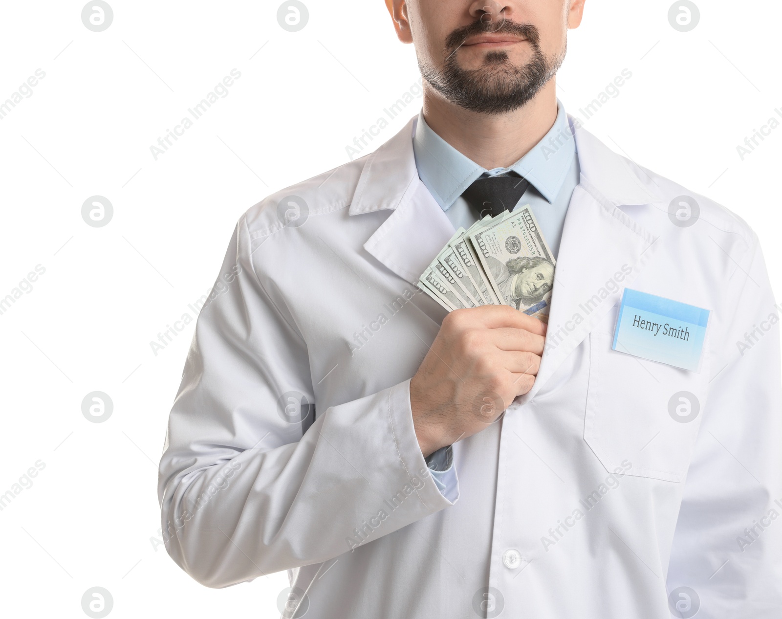 Photo of Corruption concept. Doctor putting dollar banknotes into his coat on white background, closeup