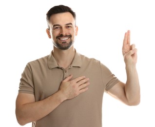 Photo of Man showing oath gesture on white background. Making promise