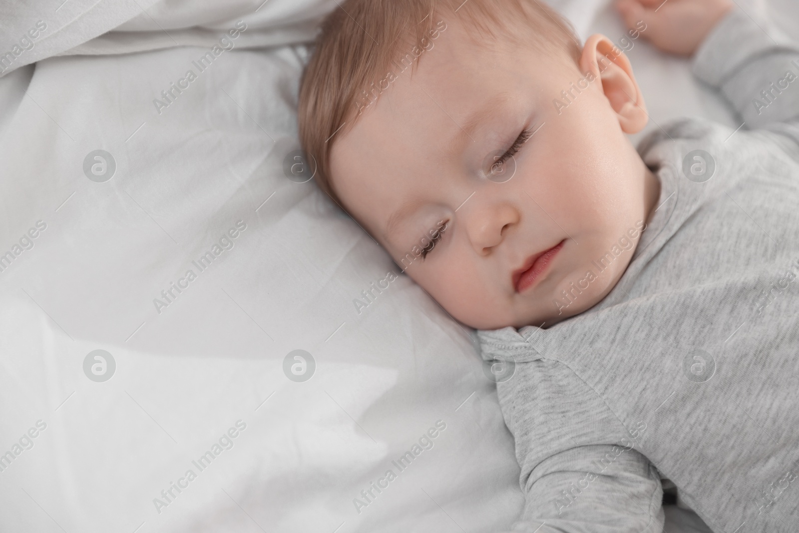 Photo of Cute little baby sleeping on bed at home