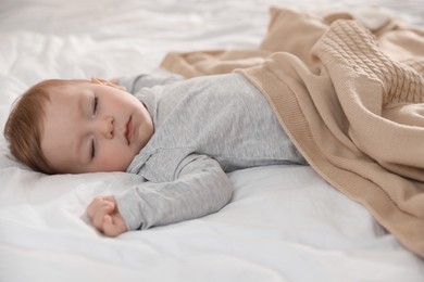 Photo of Cute little baby sleeping on bed at home