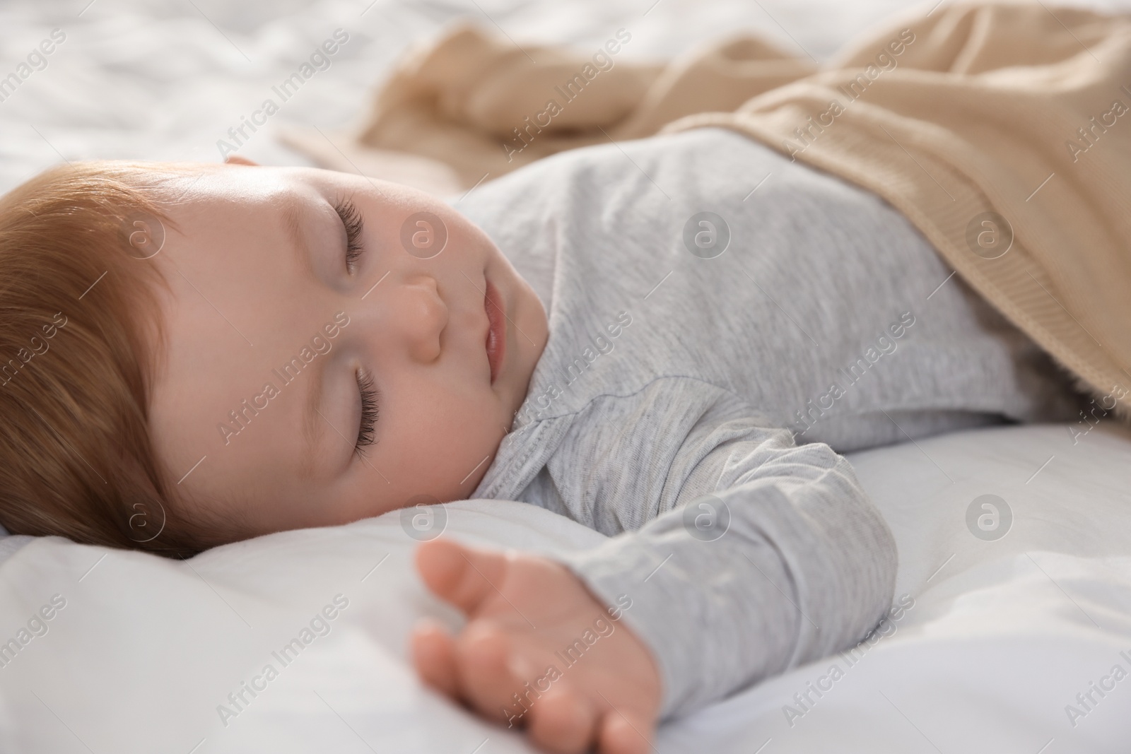 Photo of Cute little baby sleeping on bed at home