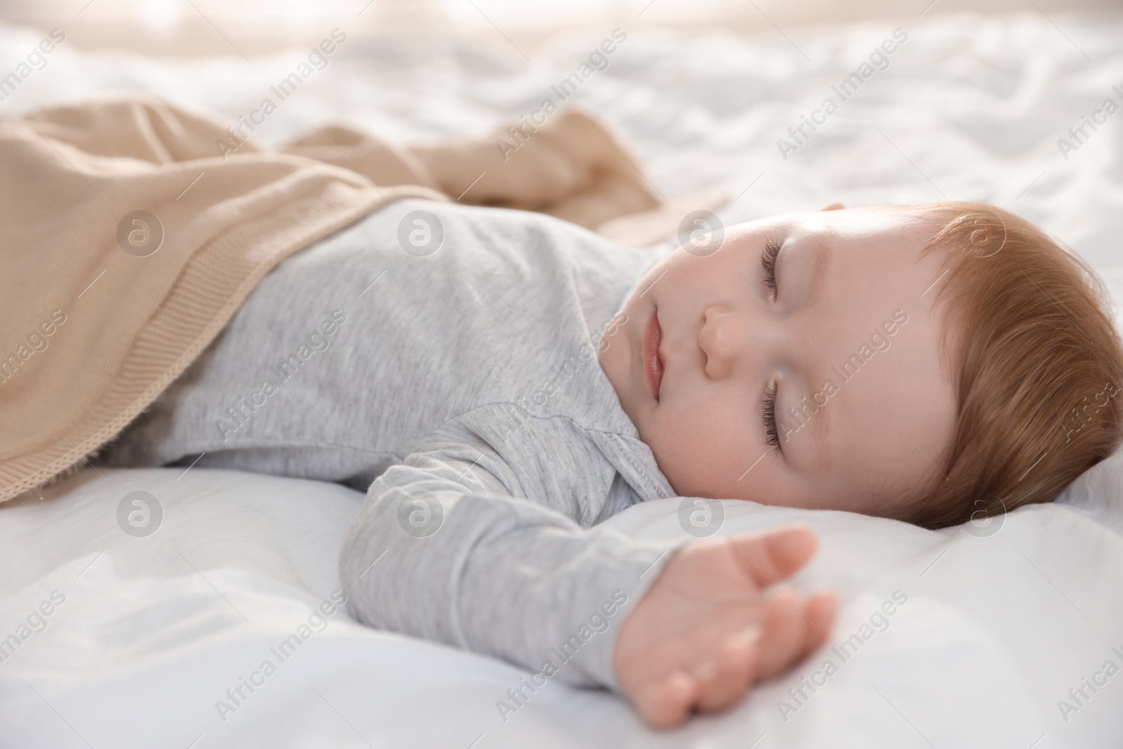 Photo of Cute little baby sleeping on bed at home