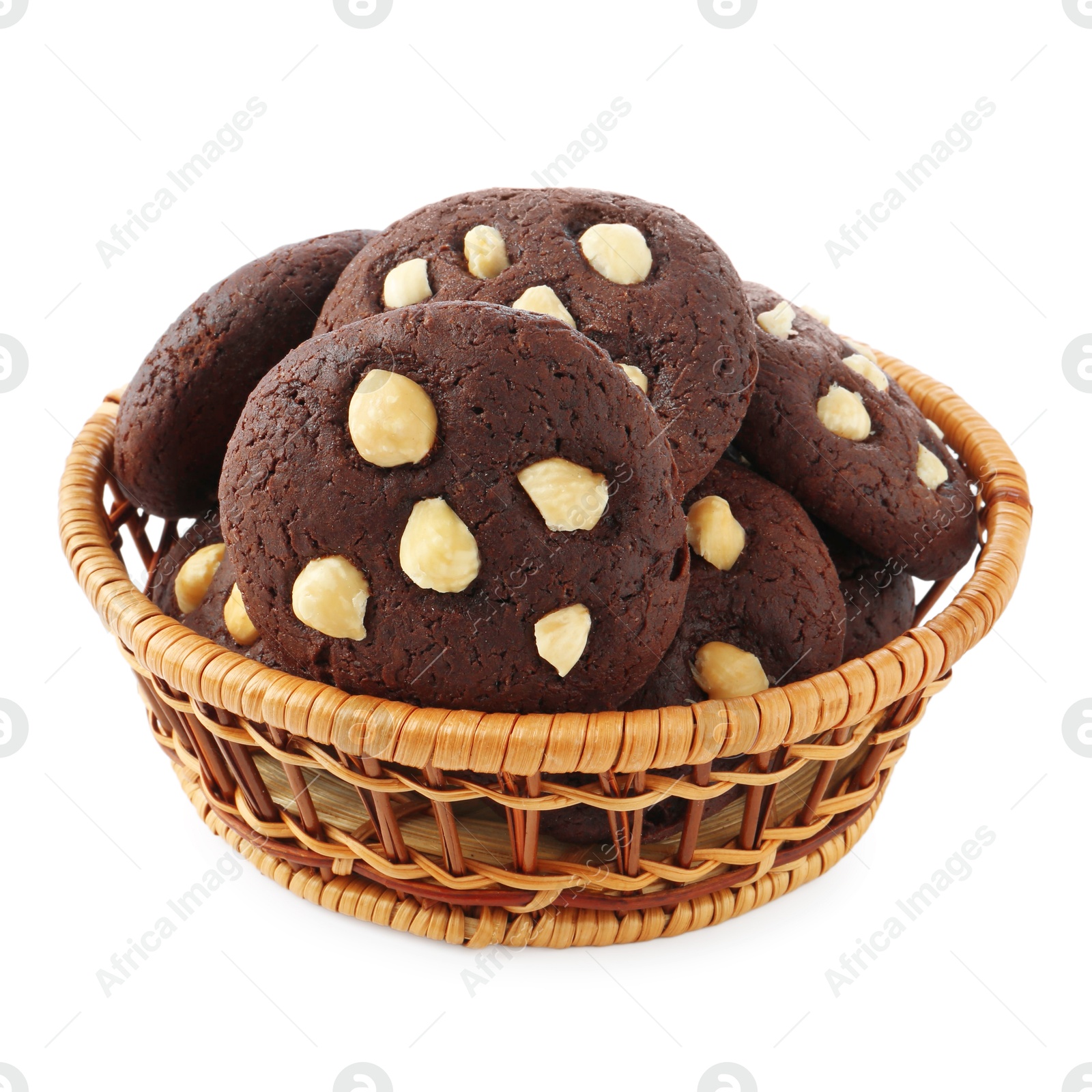 Photo of Tasty chocolate cookies with hazelnuts in wicker basket isolated on white