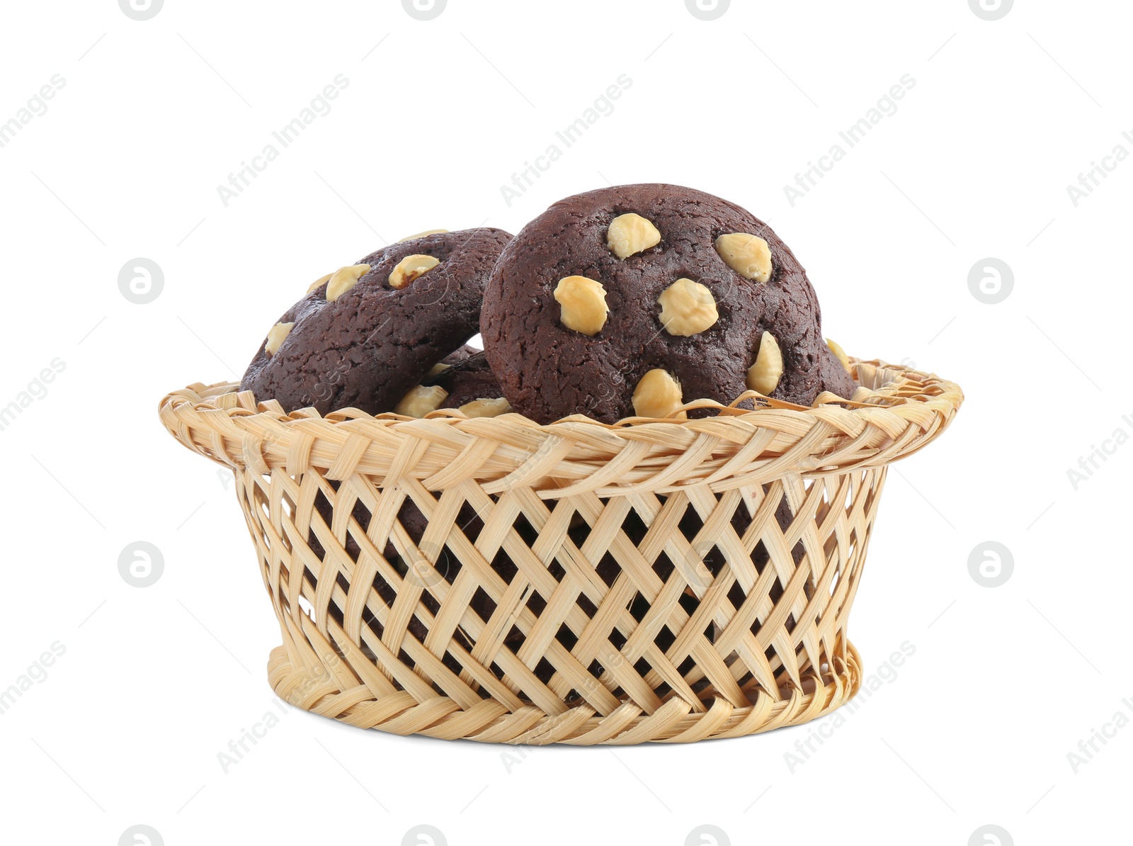 Photo of Tasty chocolate cookies with hazelnuts in wicker basket isolated on white