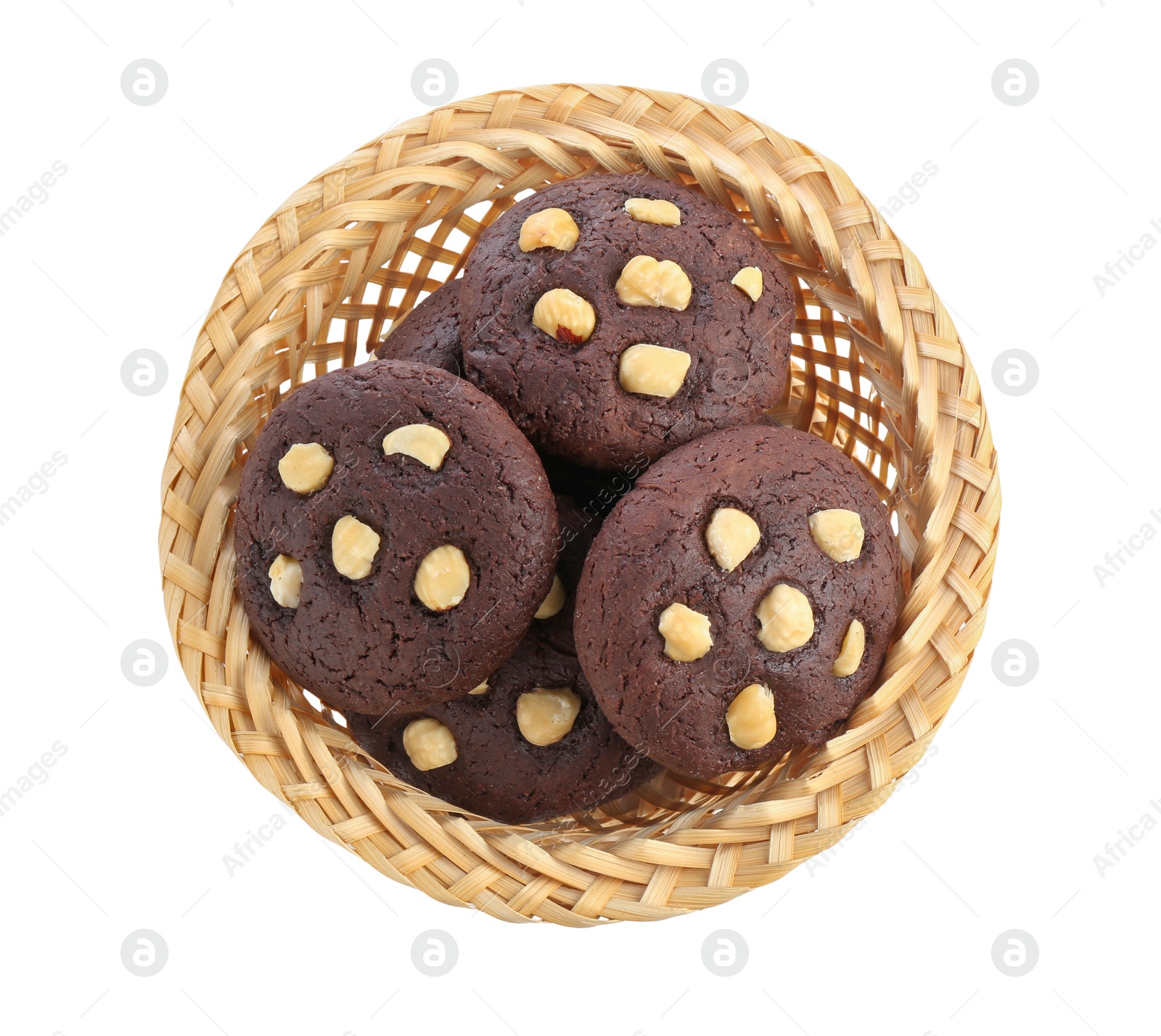 Photo of Tasty chocolate cookies with hazelnuts in wicker basket isolated on white, top view