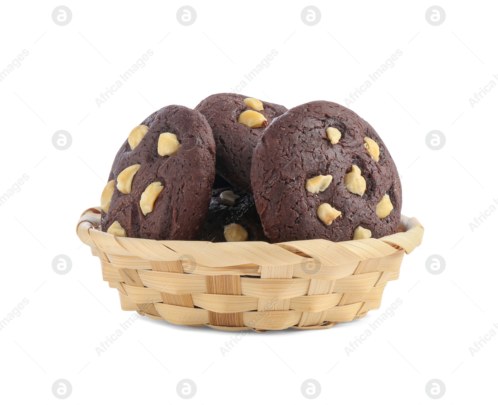 Photo of Tasty chocolate cookies with hazelnuts in wicker basket isolated on white