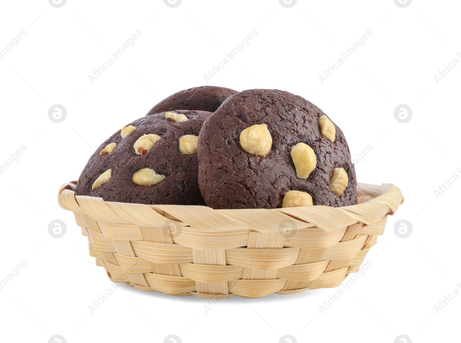 Photo of Tasty chocolate cookies with hazelnuts in wicker basket isolated on white