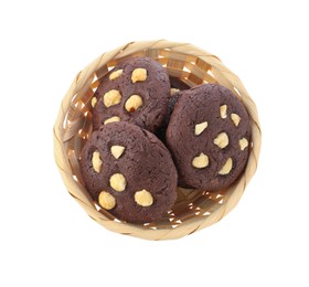 Photo of Tasty chocolate cookies with hazelnuts in wicker basket isolated on white, top view