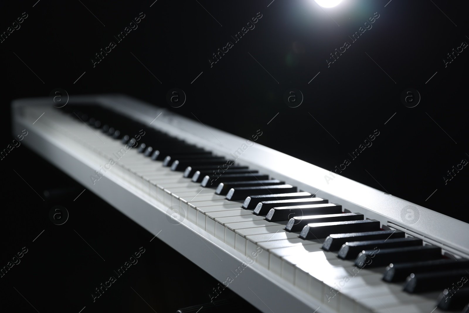 Photo of Synthesizer on black background, closeup. Electronic musical instrument