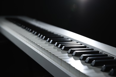 Photo of Synthesizer on black background, closeup. Electronic musical instrument