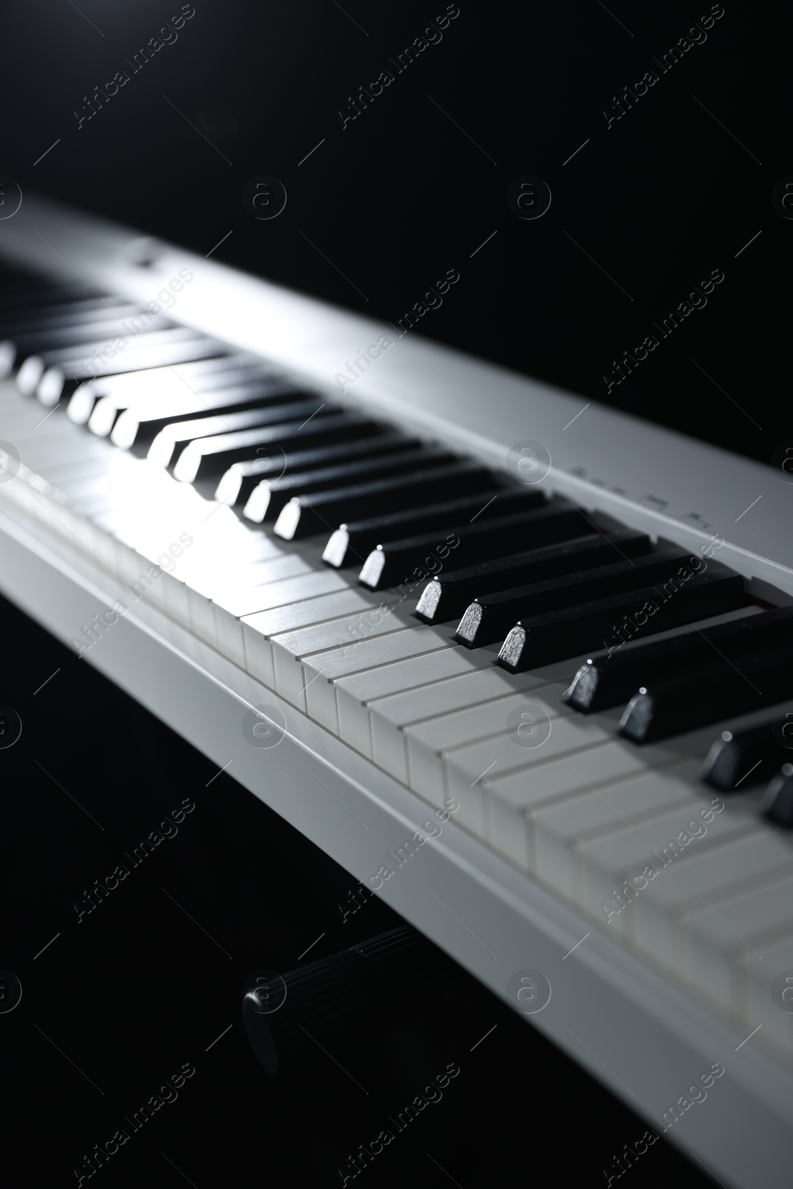 Photo of Synthesizer on black background, closeup. Electronic musical instrument