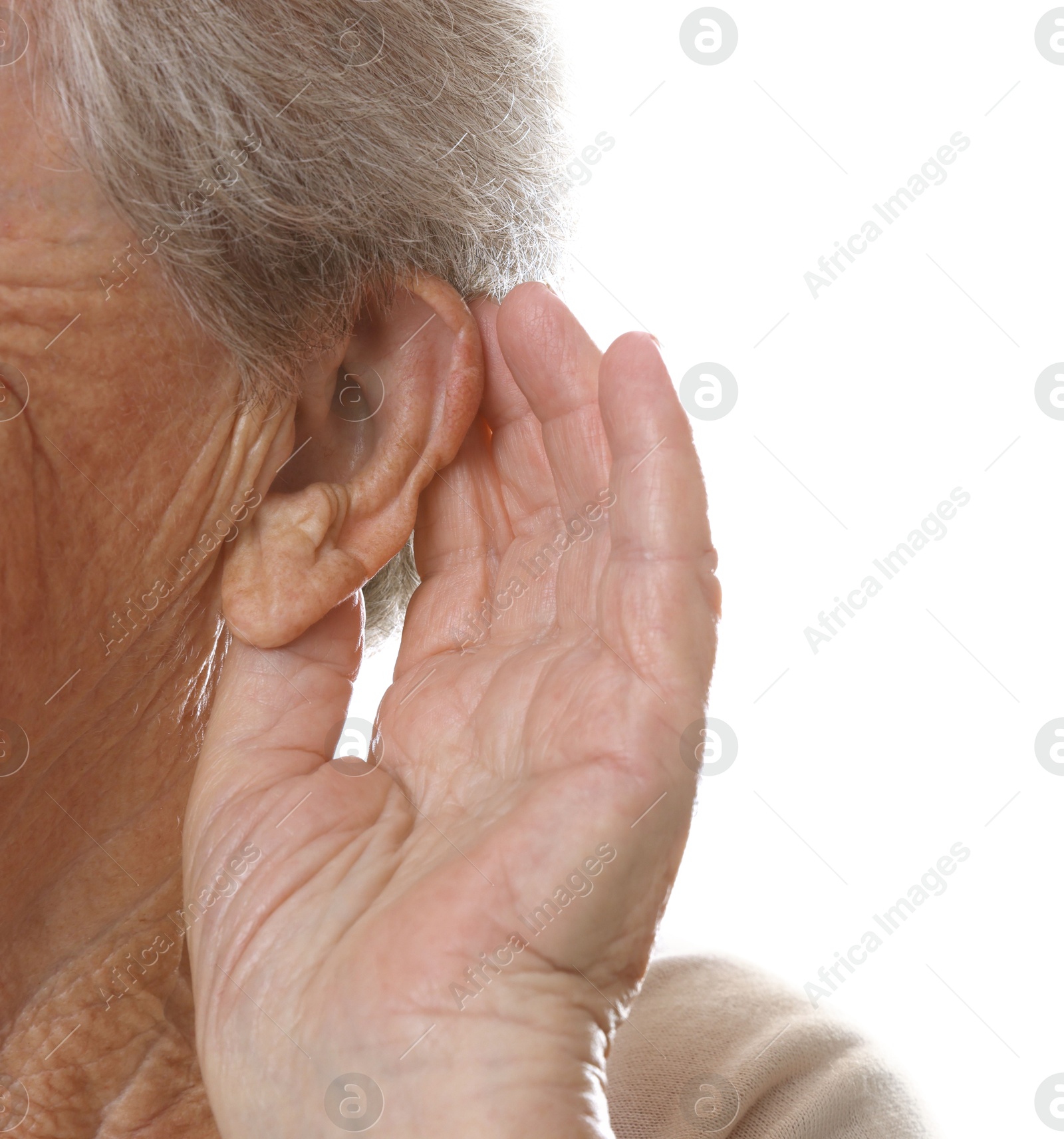 Photo of Senior woman showing hand to ear gesture on white background, closeup