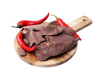 Photo of Pieces of tasty chocolate with chili peppers isolated on white