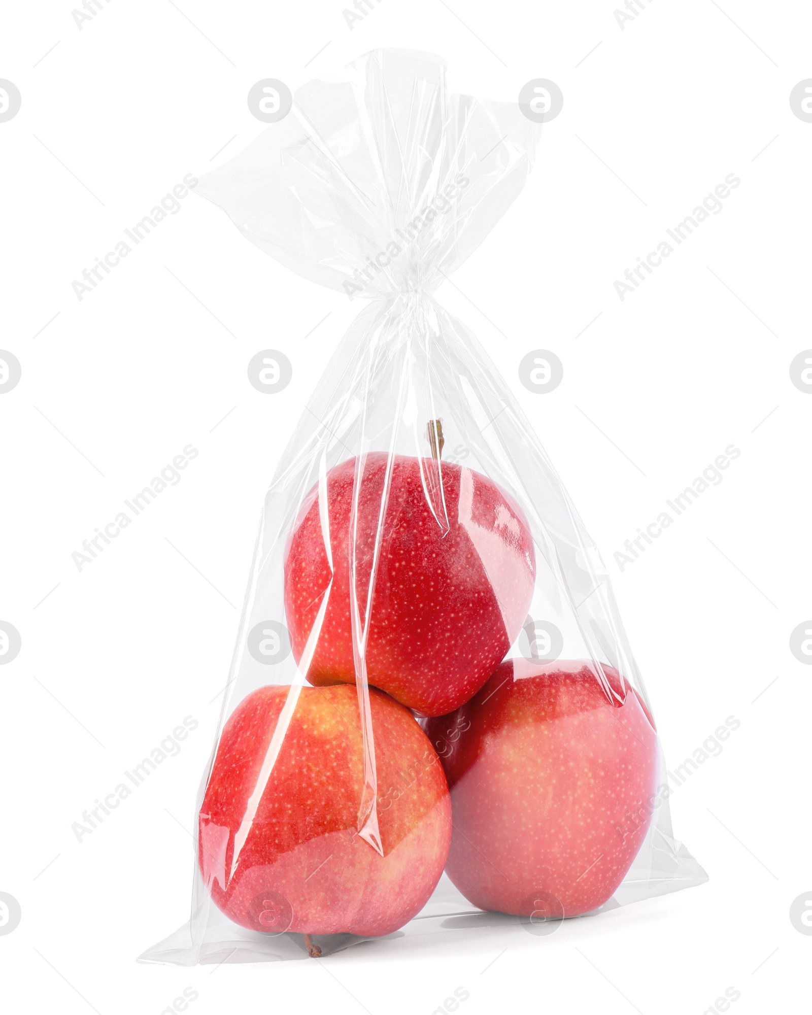 Photo of Plastic bag with red apples isolated on white