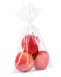 Photo of Plastic bag with red apples isolated on white