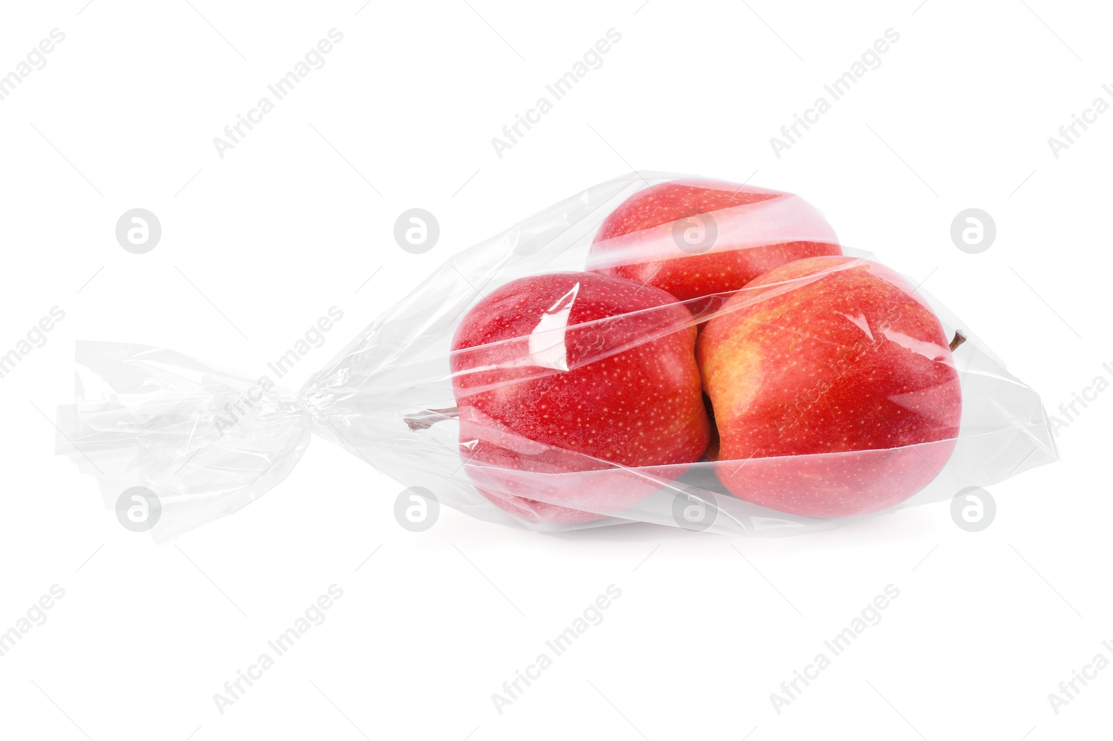 Photo of Plastic bag with red apples isolated on white