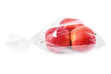 Photo of Plastic bag with red apples isolated on white