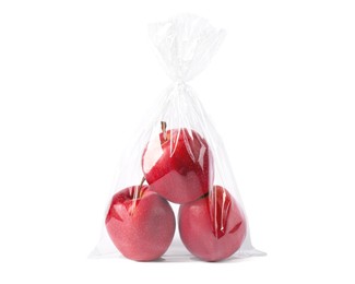 Photo of Plastic bag with red apples isolated on white