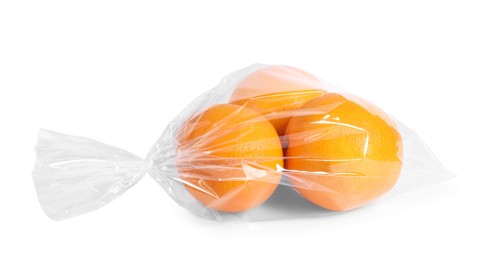 Photo of Plastic bag with fresh oranges isolated on white