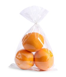 Photo of Plastic bag with fresh oranges isolated on white