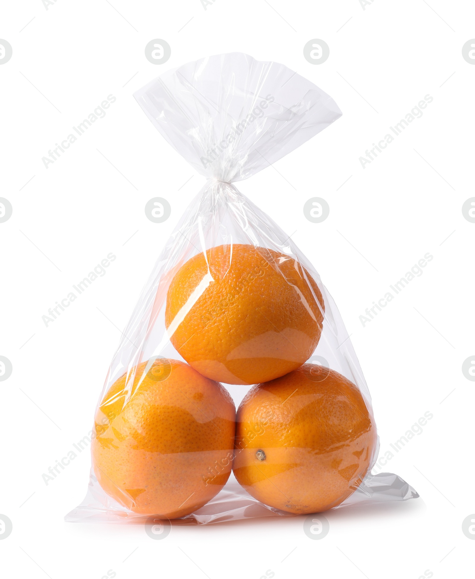 Photo of Plastic bag with fresh oranges isolated on white