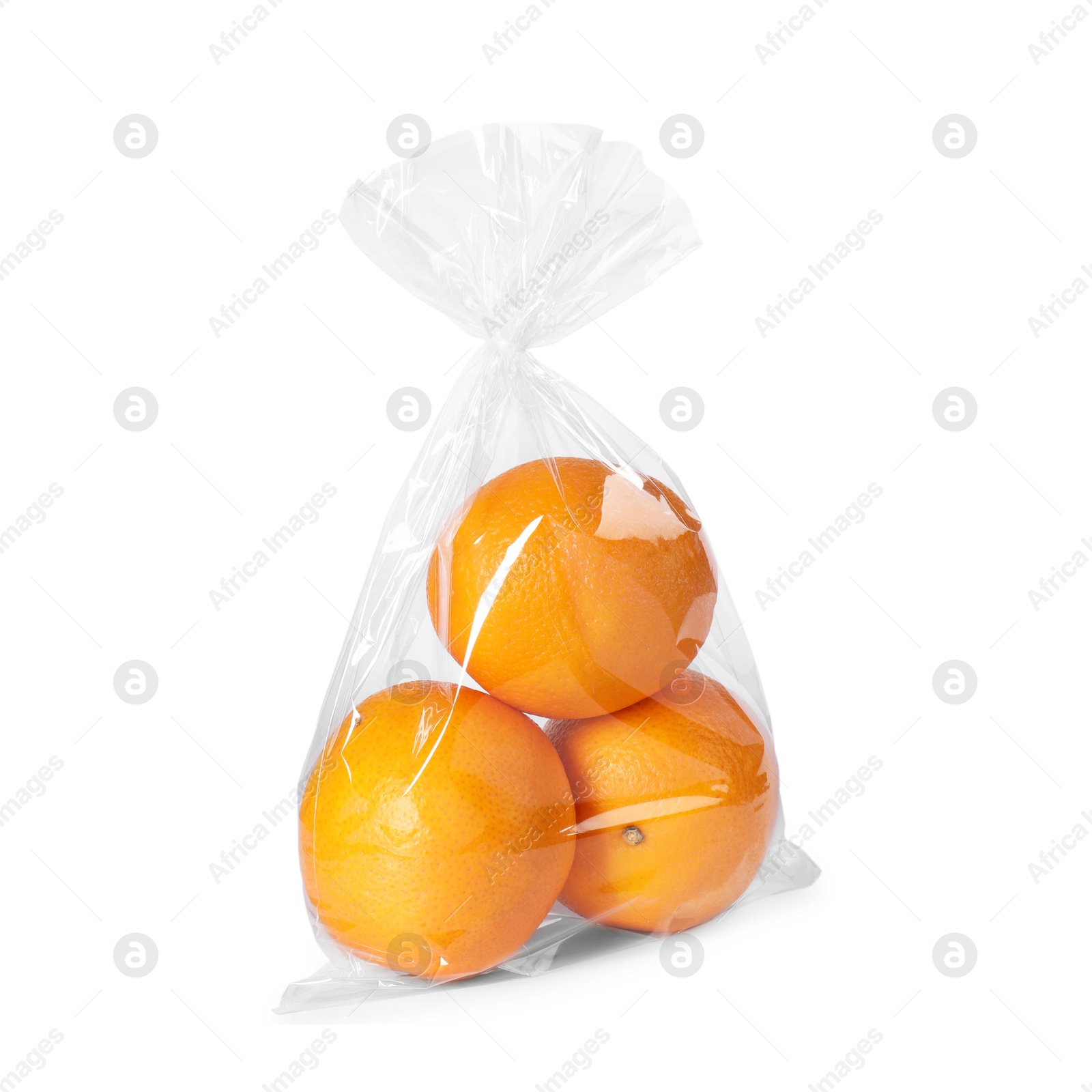 Photo of Plastic bag with fresh oranges isolated on white