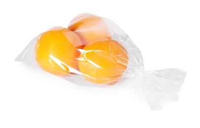 Photo of Plastic bag with fresh oranges isolated on white