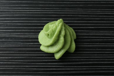 Photo of Hot wasabi paste on black textured table, top view