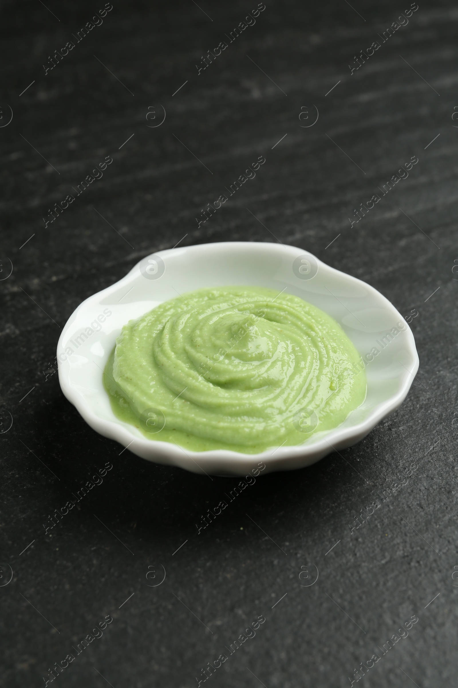 Photo of Hot wasabi paste on dark textured table