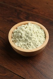 Photo of Dry wasabi powder in bowl on wooden table