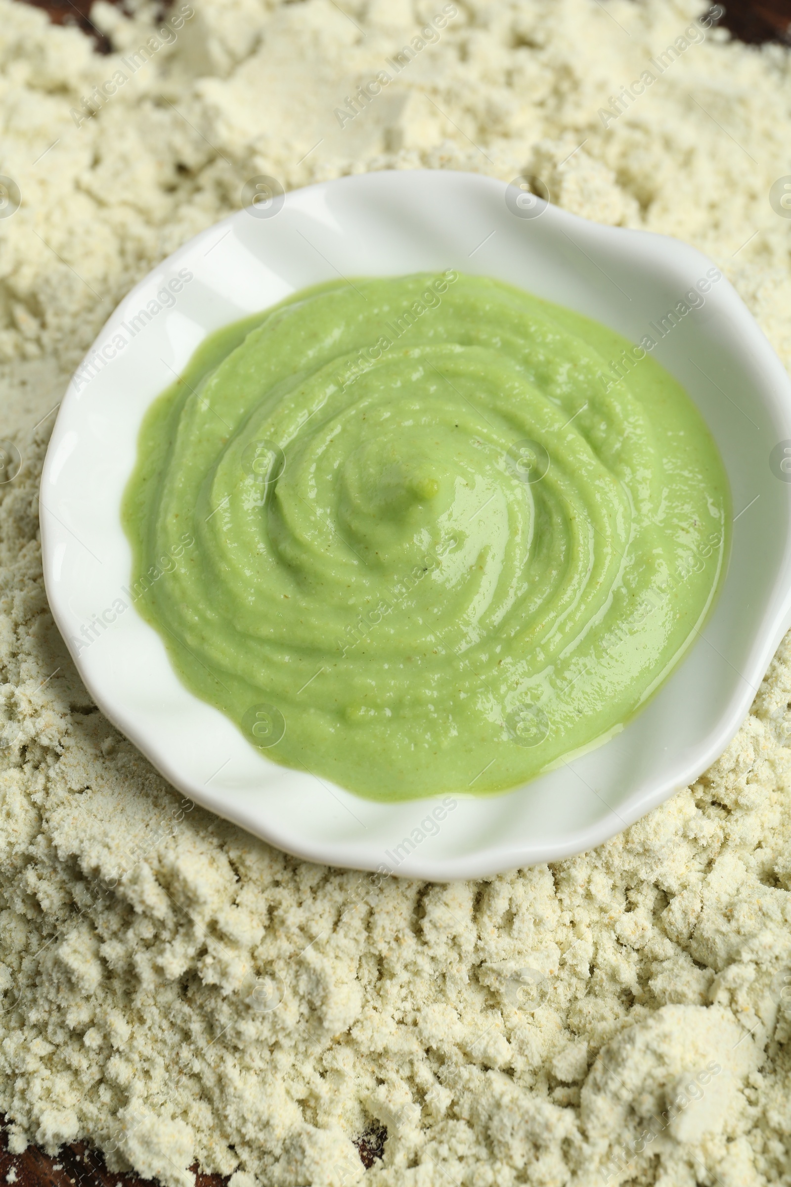 Photo of Bowl with wasabi paste on dry powder, above view