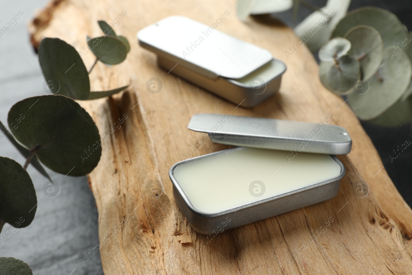 Photo of Natural solid perfume, eucalyptus and wood on table