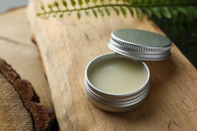 Photo of Natural solid perfume and plant on wood. Space for text