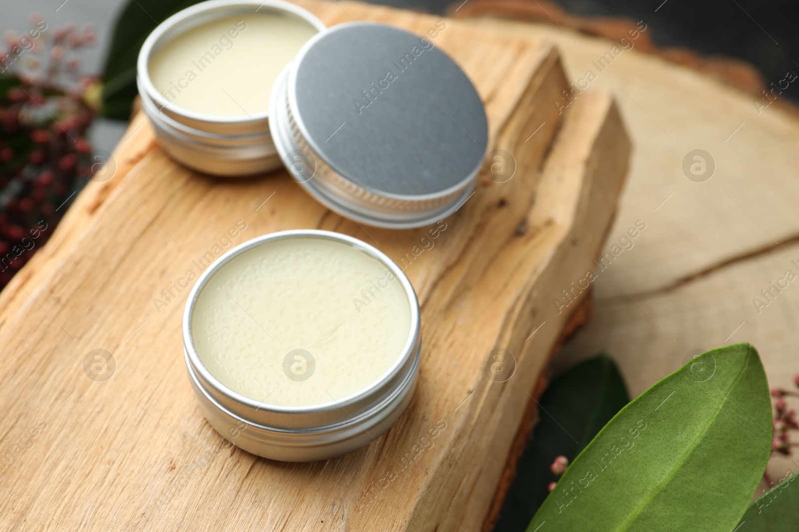 Photo of Natural solid perfume and plant on wood