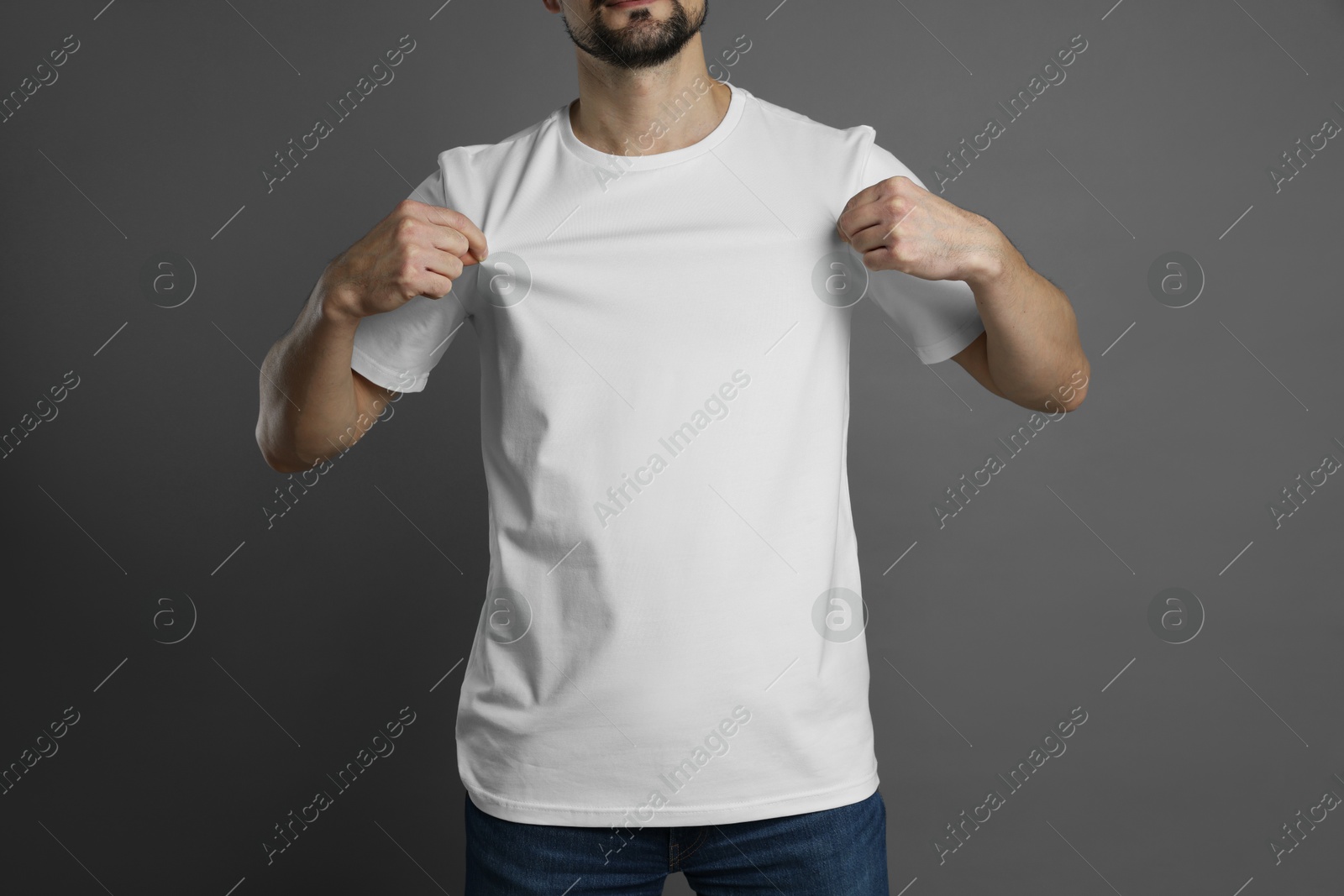 Photo of Man in blank white t-shirt on grey background, closeup. Mockup for design