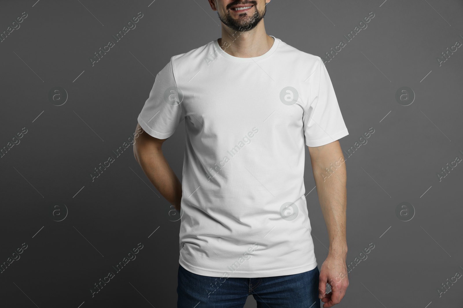 Photo of Man in blank white t-shirt on grey background, closeup. Mockup for design