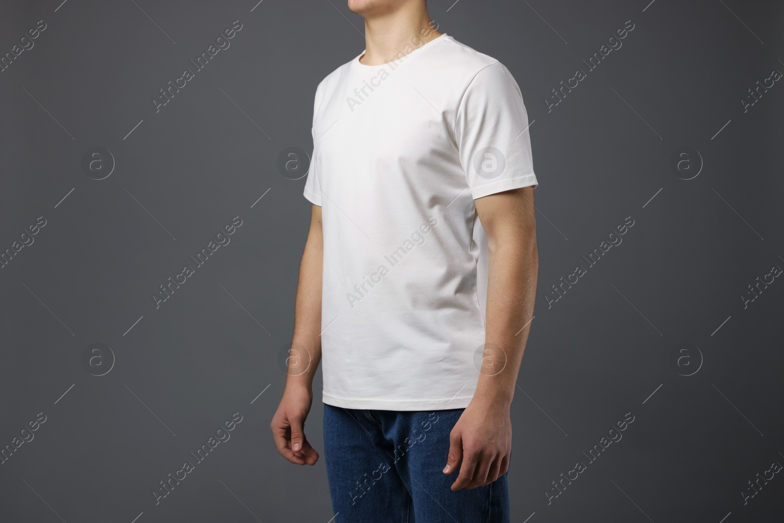 Photo of Man in stylish t-shirt on grey background, closeup. Mockup for design