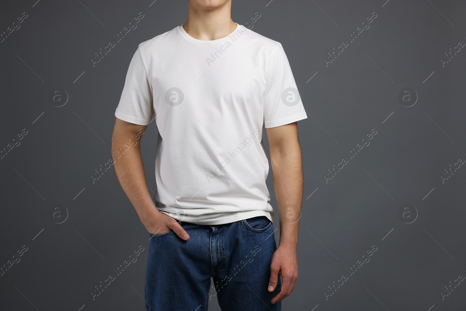 Photo of Man in stylish t-shirt on grey background, closeup. Mockup for design