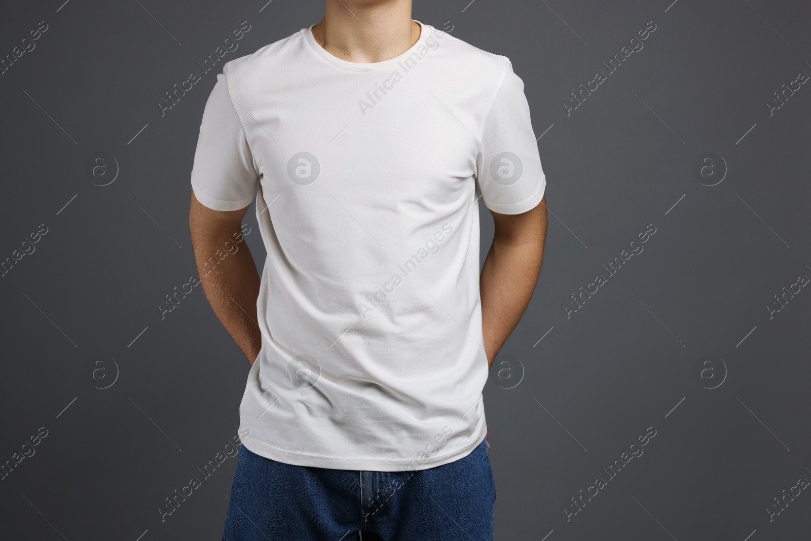 Photo of Man in stylish t-shirt on grey background, closeup. Mockup for design