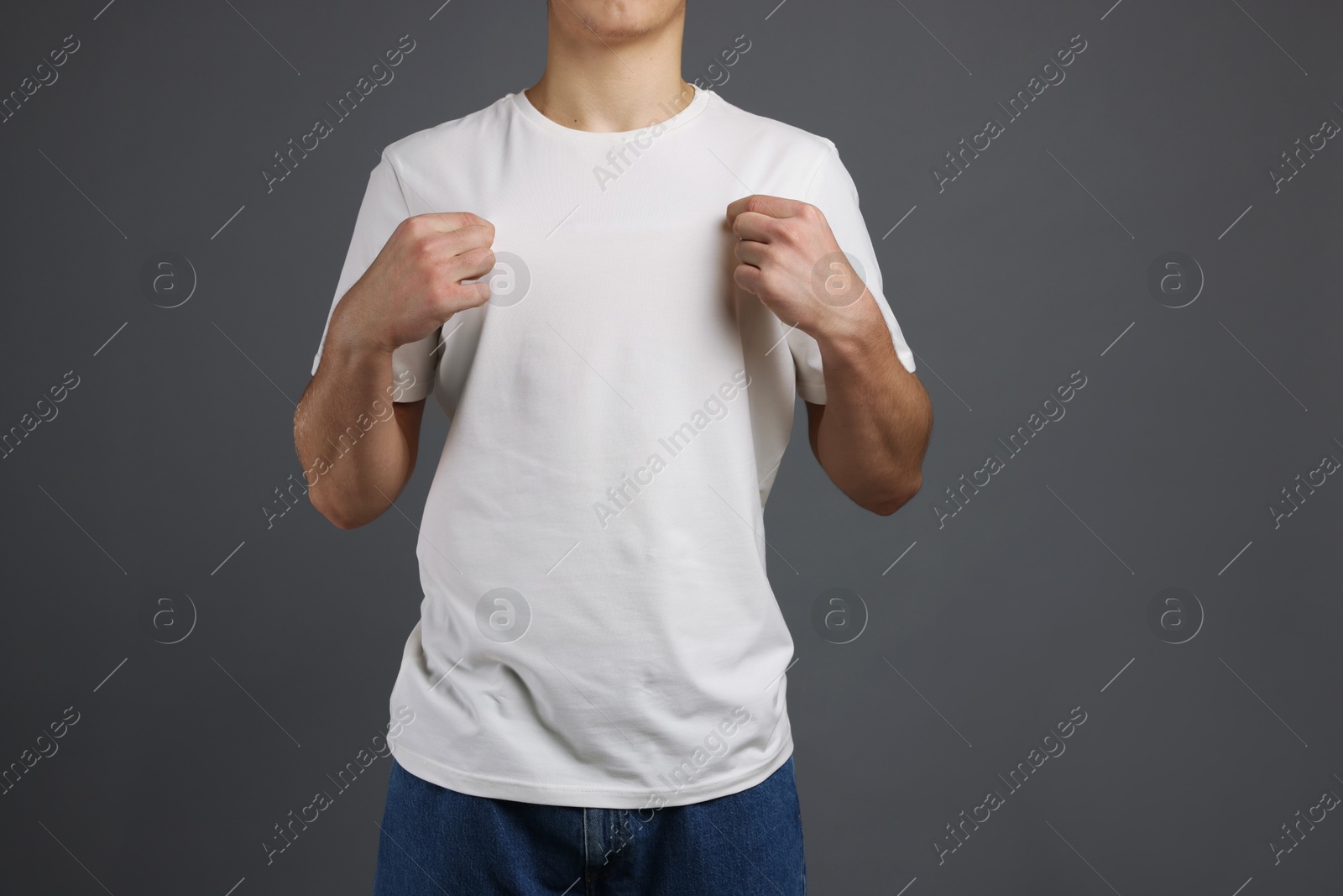 Photo of Man in stylish t-shirt on grey background, closeup. Mockup for design