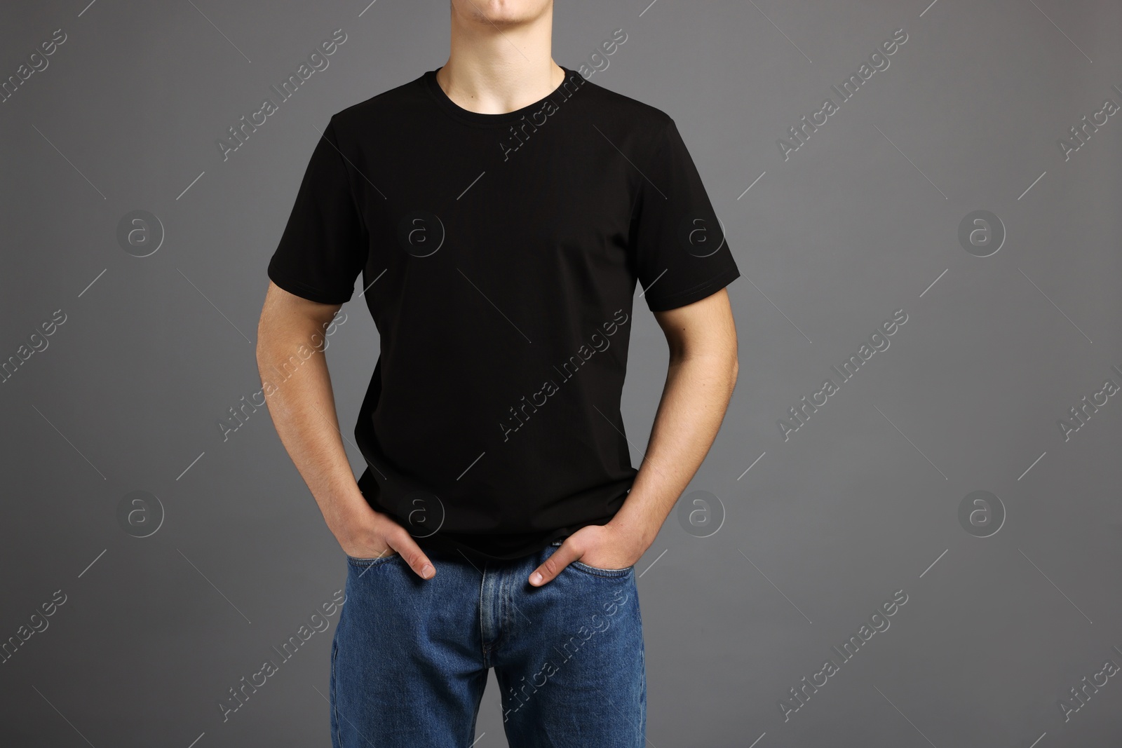 Photo of Man in stylish t-shirt on grey background, closeup. Mockup for design